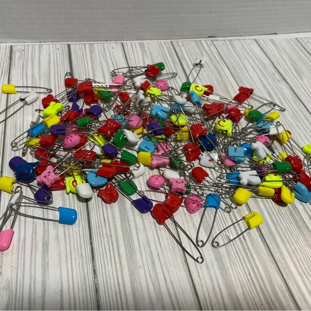 Large lot of vintage multi colored baby pins animals more
